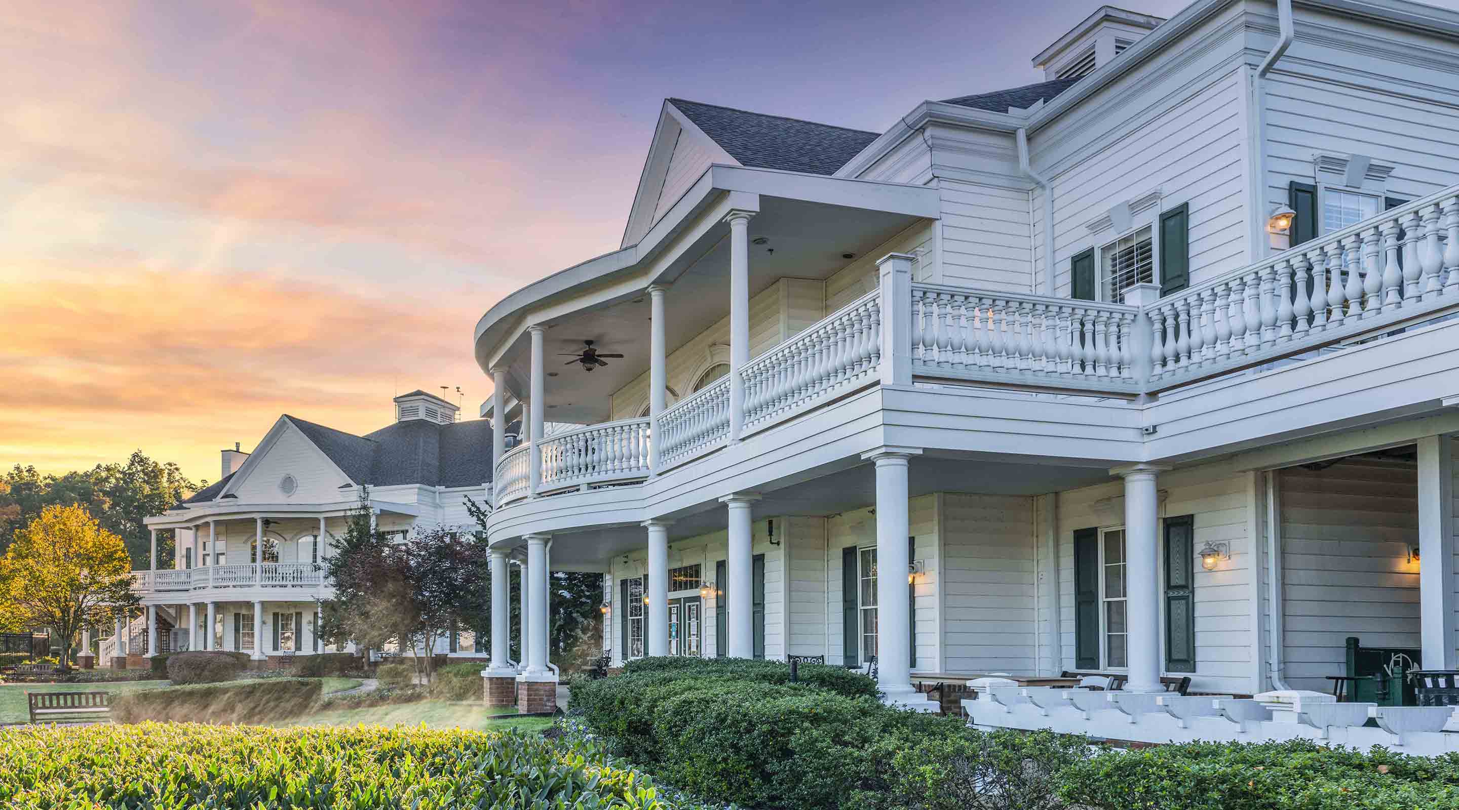 back of clubhouse with balconies and garden area